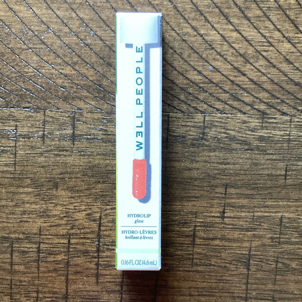 Well People lip gloss. Shade-Grapefruit Pamplemousse. Never used. EWG Certified